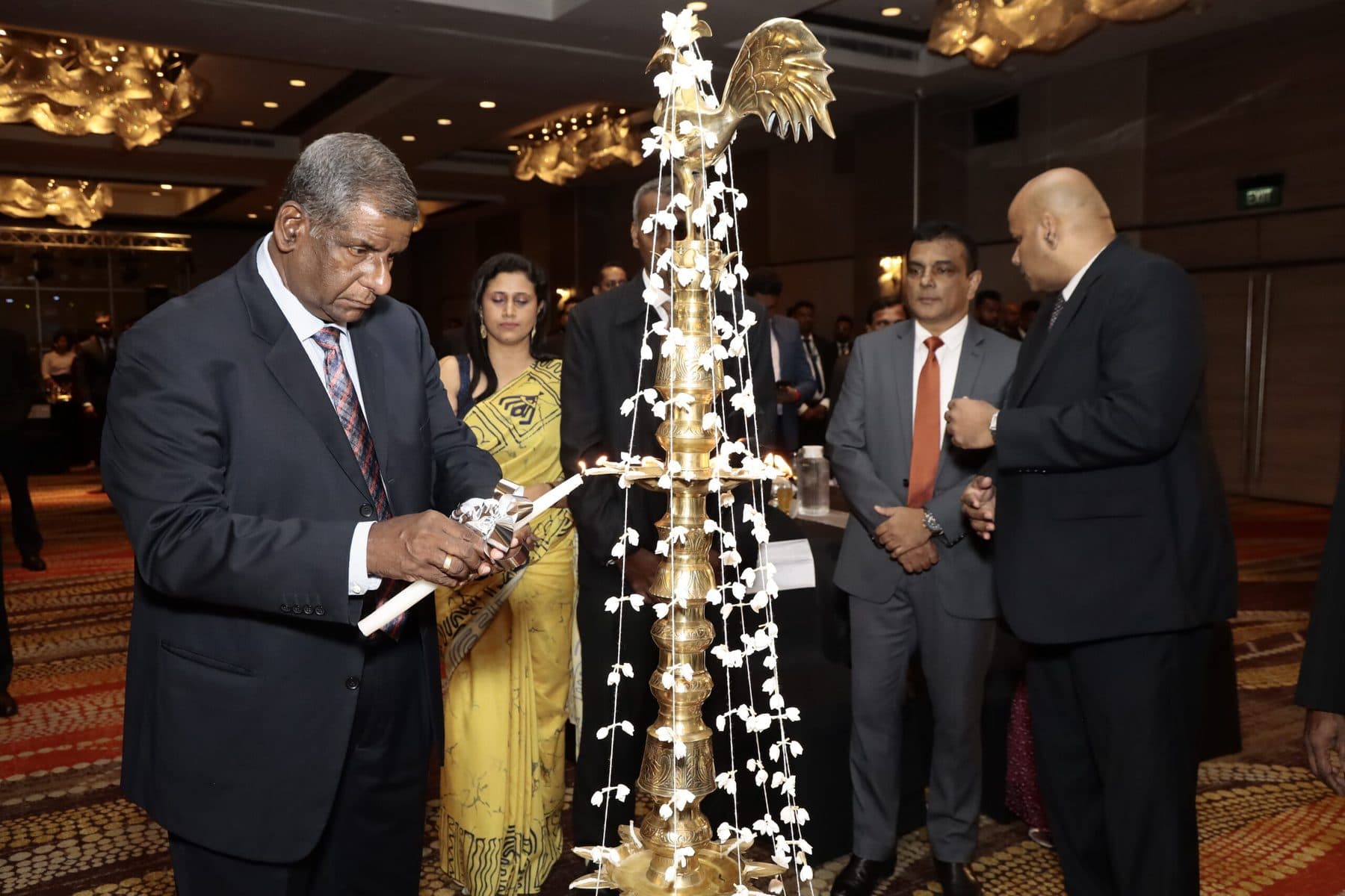 Lighting the oil lamp to open the People Development Awards