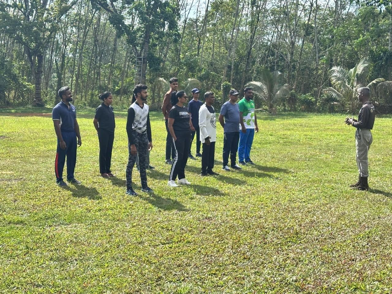 Students listening to an instructor during field training